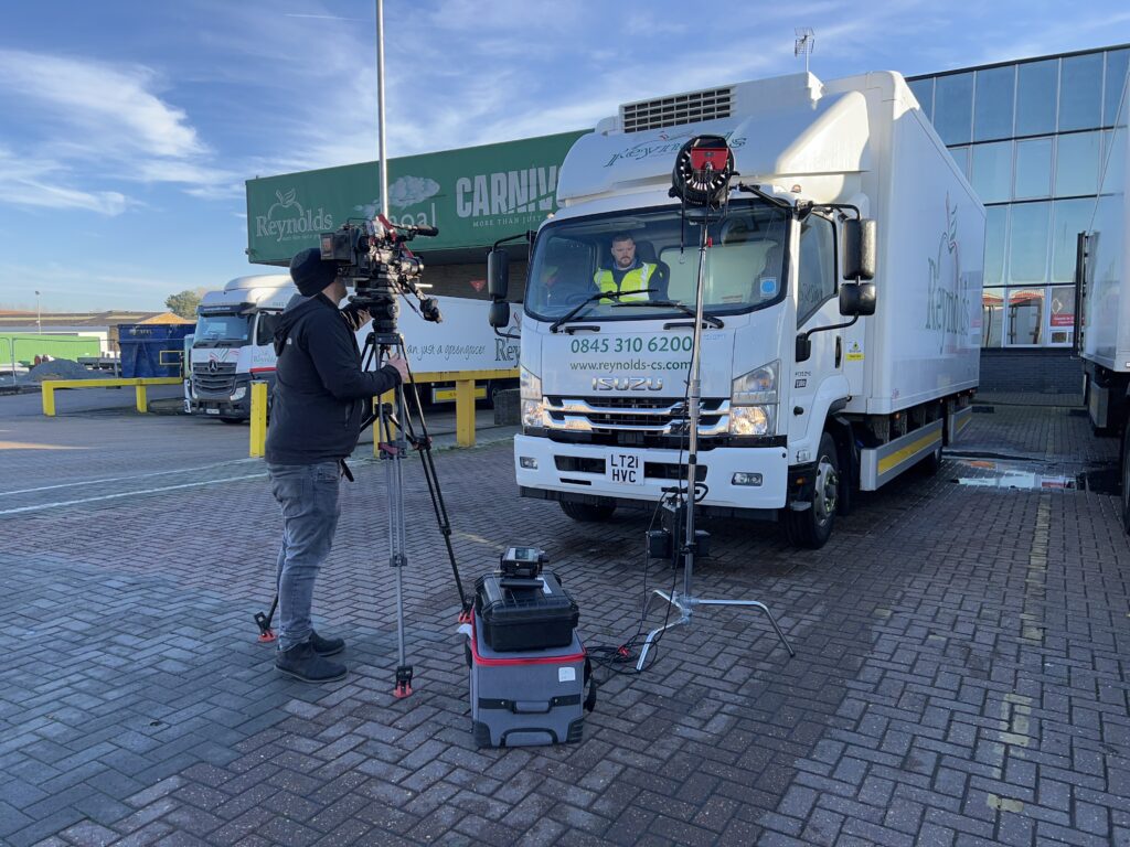 Filming a safety demonstration video on a Sony FX9 camera with Canon cine prime lens, lit by professional Aputure lighting equipment. A health and safety professional is sitting in the cab of a lorry demonstrating correct operating procedures