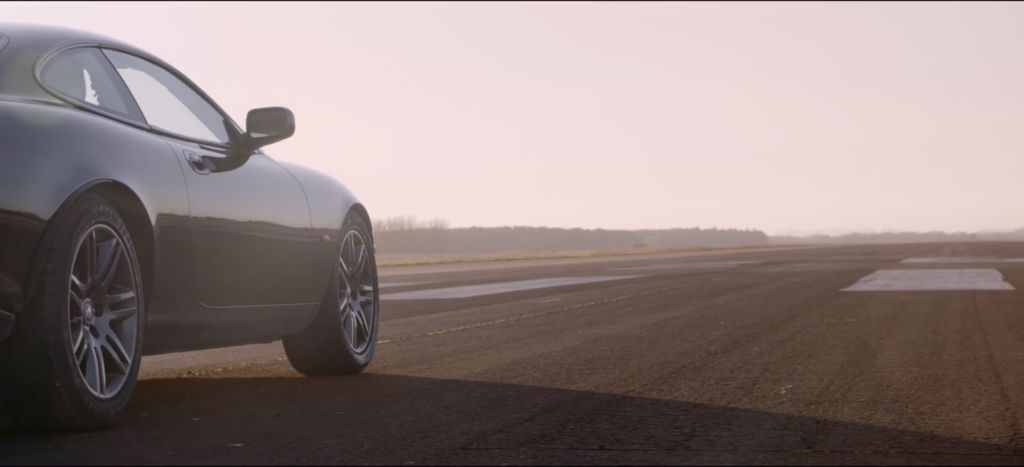 This is the featured image for our blog detailing our Video Pre-production checklist. A sleek sports car is parked on an empty runway under a clear sky, with the horizon visible in the distance. All the production checks are complete & it is now ready for a safe drive down the runway as part of a filming project